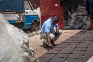 在加纳的阿克拉郊区，一名工程师正在检查由回收塑料制成的铺路石。