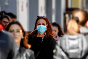 本月，一名女子戴着面具走在意大利那不勒斯的街道上。中国是新冠肺炎疫情的重灾区。