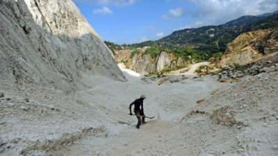 一名工作者在2014年4月的海地港口奥地蒂普林斯港附近收集沙子。