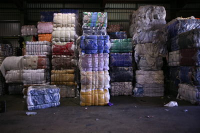 堆被丢弃的纺织品准备好回收。