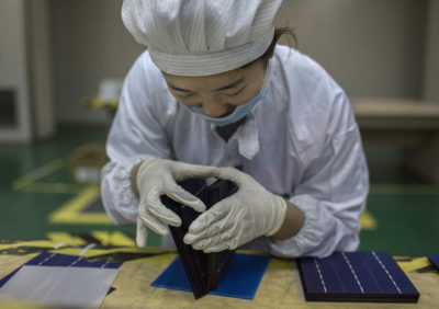技术人员在中国河北省英利太阳能的生产线上检查了太阳能电池。